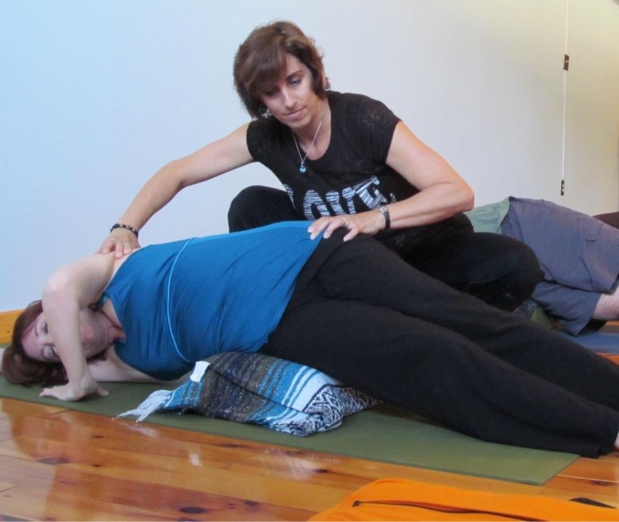 lisa long helps a yoga student feel better