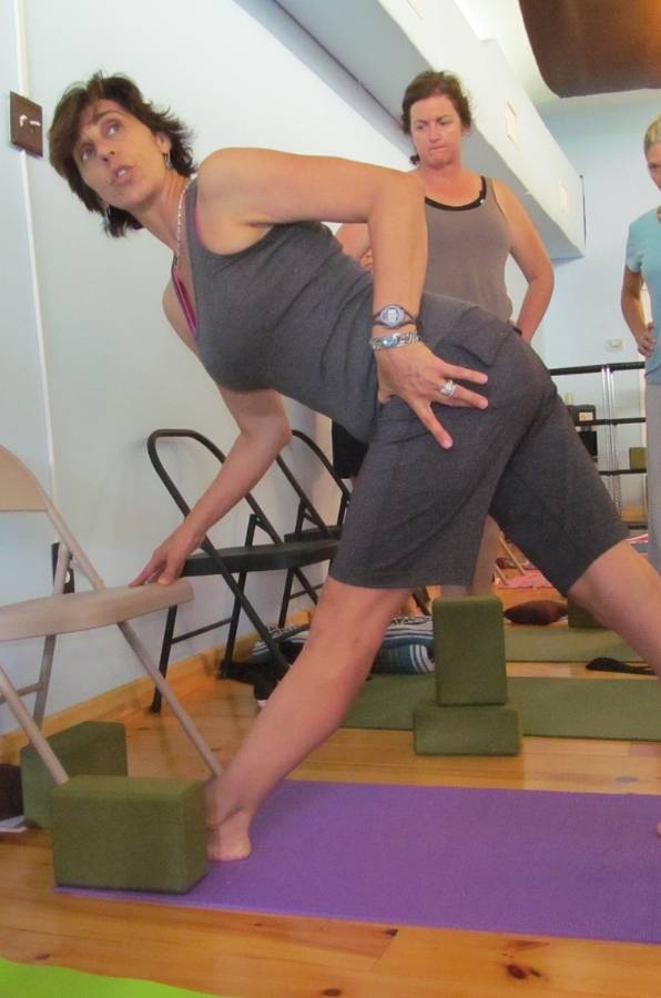 lisa long leading a yoga therapy workshop in revolved triangle pose